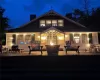 Back house at night with a wooden deck