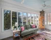 Sunroom / solarium featuring ceiling fan and a healthy amount of sunlight