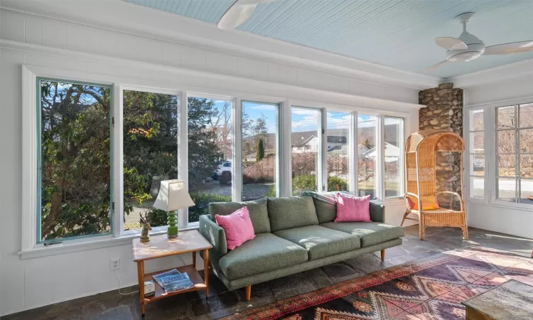 Sunroom / solarium featuring ceiling fan and a healthy amount of sunlight