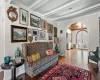 Living room featuring light hardwood / wood-style floors, beam ceiling, and french doors