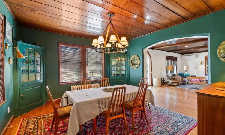 Dining room with beam ceiling, wood ceiling, a chandelier, and hardwood / wood-style flooring