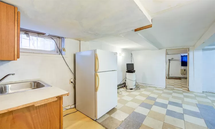 Kitchen featuring white fridge and sink