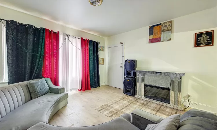 Living room with a wealth of natural light and light hardwood / wood-style flooring