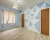 Spare room featuring wood-type flooring and a notable chandelier