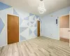 Empty room featuring a chandelier and light wood-type flooring