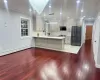 Kitchen with kitchen peninsula, black refrigerator, backsplash, hanging light fixtures, and crown molding