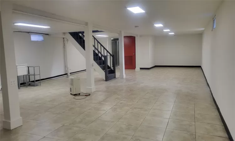 Basement featuring light tile patterned floors