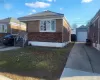 View of front facade featuring an outbuilding and a garage