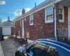 View of home's exterior with a garage and an outbuilding