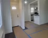 Entrance foyer with sink, a wealth of natural light, dark hardwood / wood-style floors, and crown molding