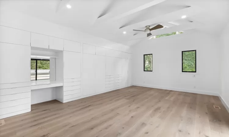 Unfurnished bedroom featuring ceiling fan, multiple windows, and light hardwood / wood-style floors