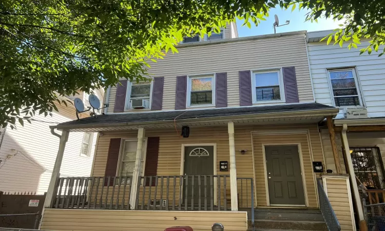 Multi unit property featuring covered porch and cooling unit