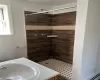 Bathroom featuring vanity and tiled shower