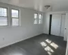 Unfurnished bedroom featuring a closet and dark hardwood / wood-style floors