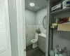 Bathroom with tile walls, toilet, vanity, and hardwood / wood-style floors