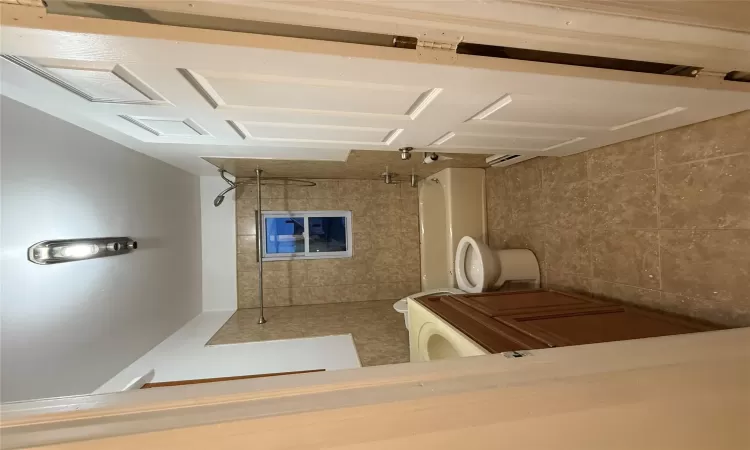 Second Full bathroom featuring a baseboard heating unit, toilet, vanity, and tiled shower / bath