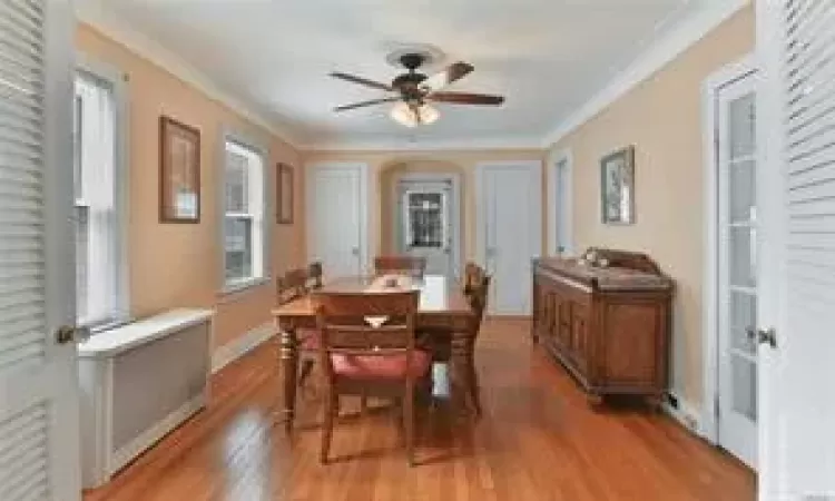 Dining room with ceiling fan, crown molding, and hardwood / wood-style floors