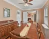 Dining space featuring ceiling fan, ornamental molding, and a fireplace