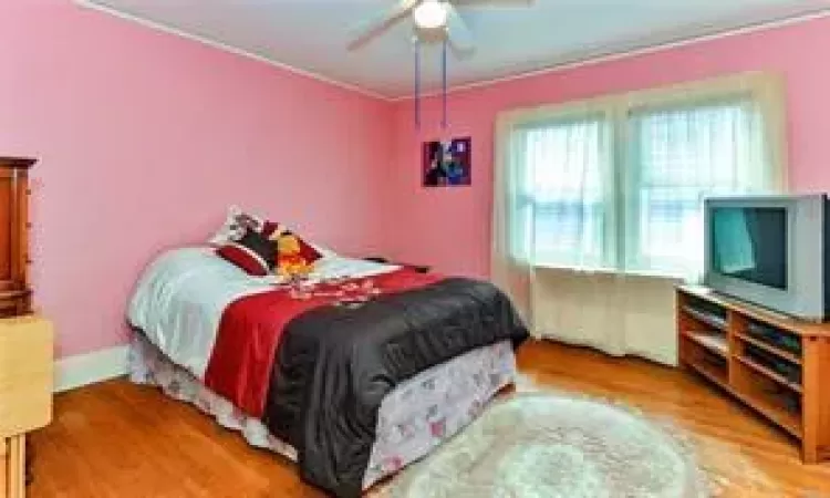 Bedroom with ceiling fan and light hardwood / wood-style flooring