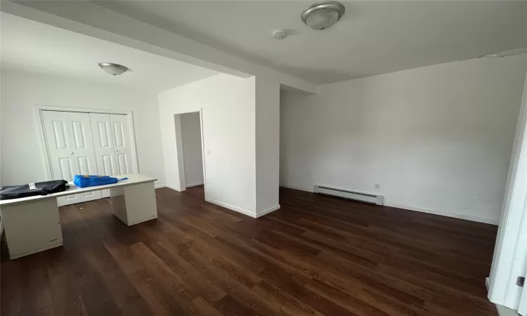 Unfurnished bedroom with dark wood-type flooring