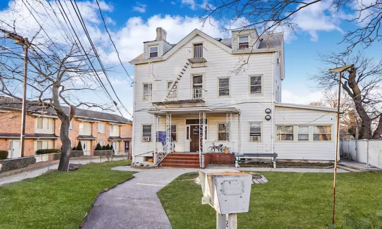 View of front of property with a front yard