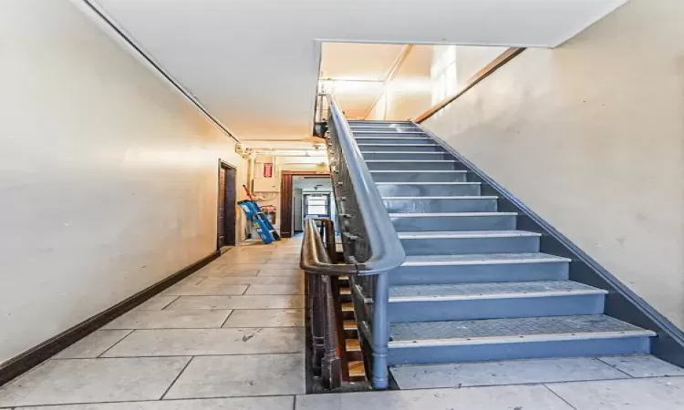 Stairs with tile patterned floors