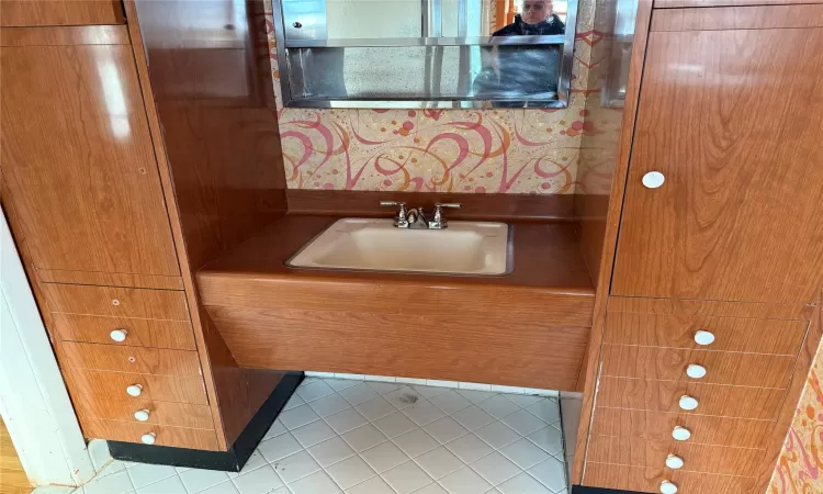 Bathroom featuring tile patterned floors and vanity