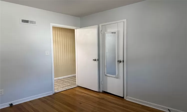 Unfurnished bedroom featuring hardwood / wood-style floors