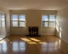 Unfurnished living room featuring a fireplace, ornamental molding, and dark hardwood / wood-style floors