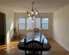 Dining area with dark hardwood / wood-style floors and a chandelier