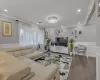 Living room featuring wood-type flooring and ornamental molding