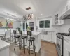 Kitchen featuring white cabinetry, a center island, and appliances with stainless steel finishes