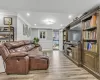 Living room with light hardwood / wood-style floors and ornamental molding