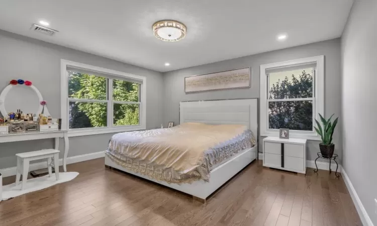 Bedroom with hardwood / wood-style flooring