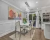 Dining area featuring a notable chandelier, dark hardwood / wood-style flooring, and ornamental molding