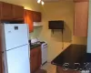 Kitchen featuring light tile patterned floors and white appliances