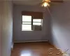 Spare room featuring ceiling fan, a baseboard heating unit, and hardwood / wood-style floors