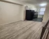 Kitchen with black fridge and white cabinetry