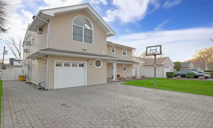 View of front of property with a front lawn and a garage