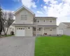 View of front of property with a front yard and a garage