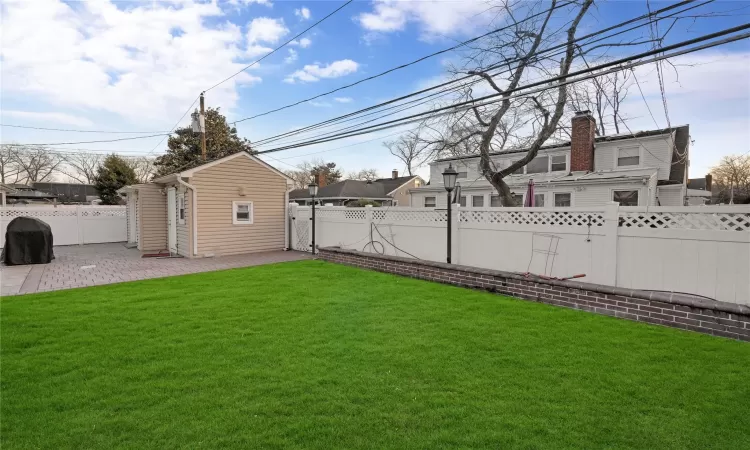 View of yard with a patio area and an outdoor structure