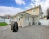 Back of house with ac unit, a patio, and a wall unit AC