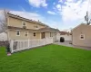 Rear view of property with a yard and a patio