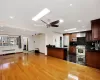 Kitchen with radiator heating unit, wood-type flooring, built in appliances, tasteful backsplash, and sink