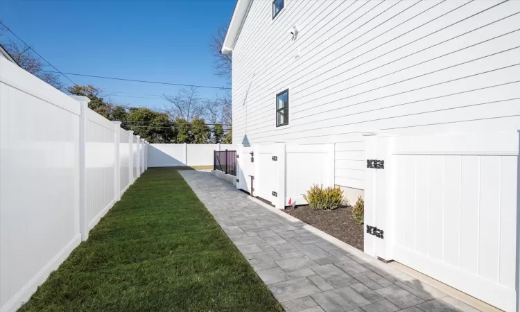 Side of yard with stairs to basment