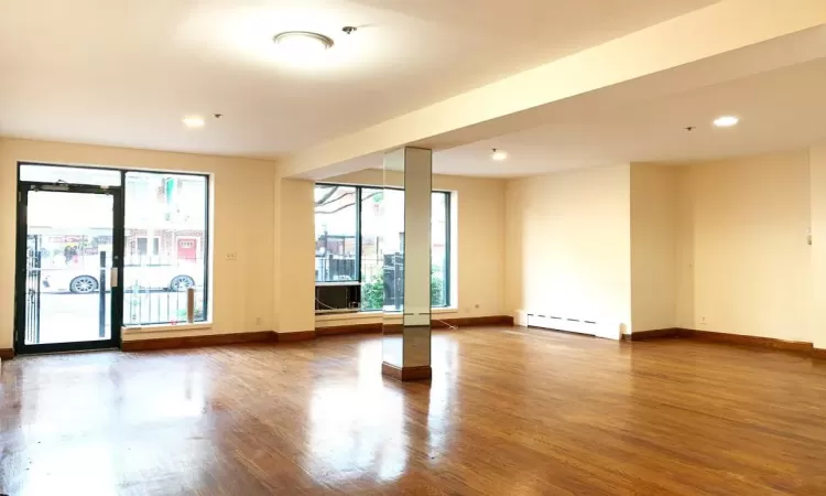 Spare room with hardwood / wood-style flooring and a baseboard radiator