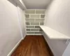 Walk in closet featuring dark hardwood / wood-style floors