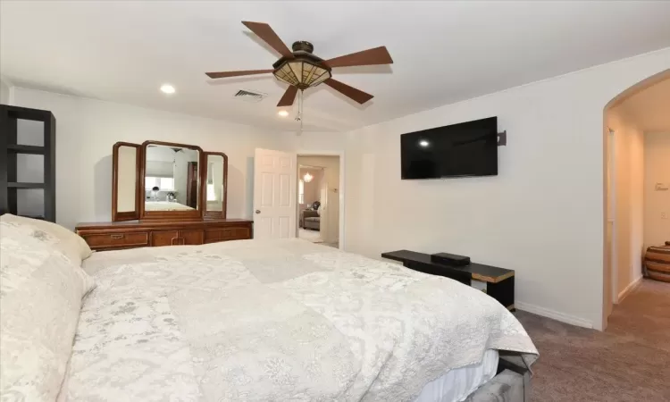 Bedroom featuring ceiling fan and carpet flooring