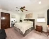 Carpeted bedroom featuring ceiling fan