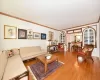 Living room featuring a chandelier, ornamental molding, and hardwood / wood-style flooring